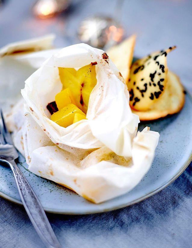 Mango papillotes with spices, black sesame tiles